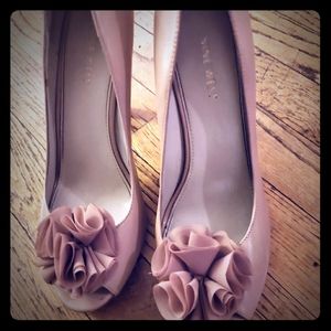 Nine west tan heels with flower on on each toe.